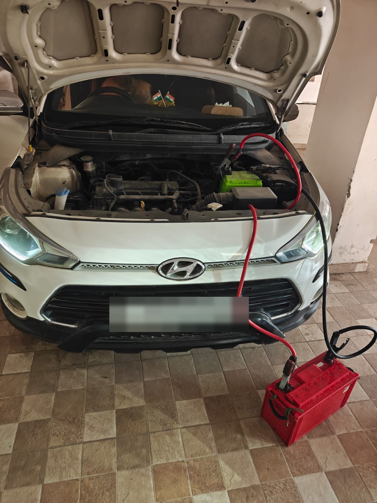 Hyundai i20 connected to a jump start battery during OnRoads India assistance