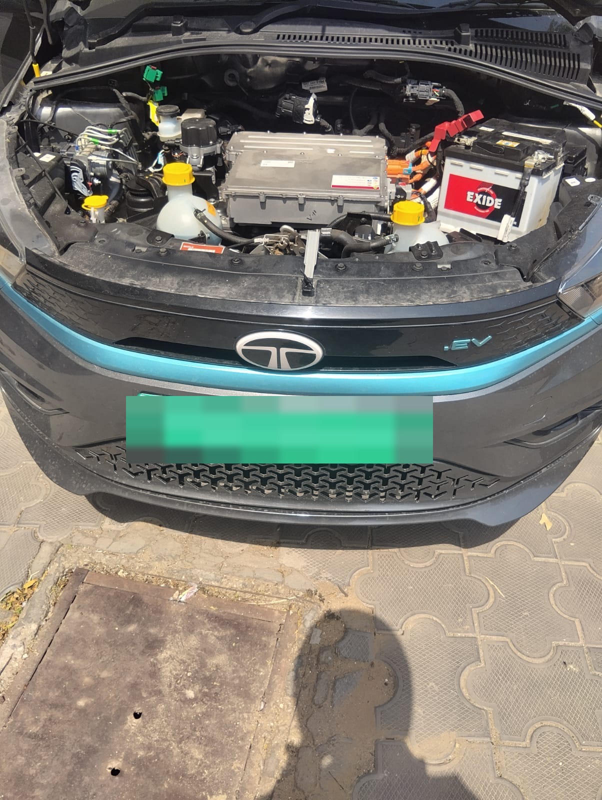Tata Tiago EV with bonnet open during OnRoads India 12V battery support